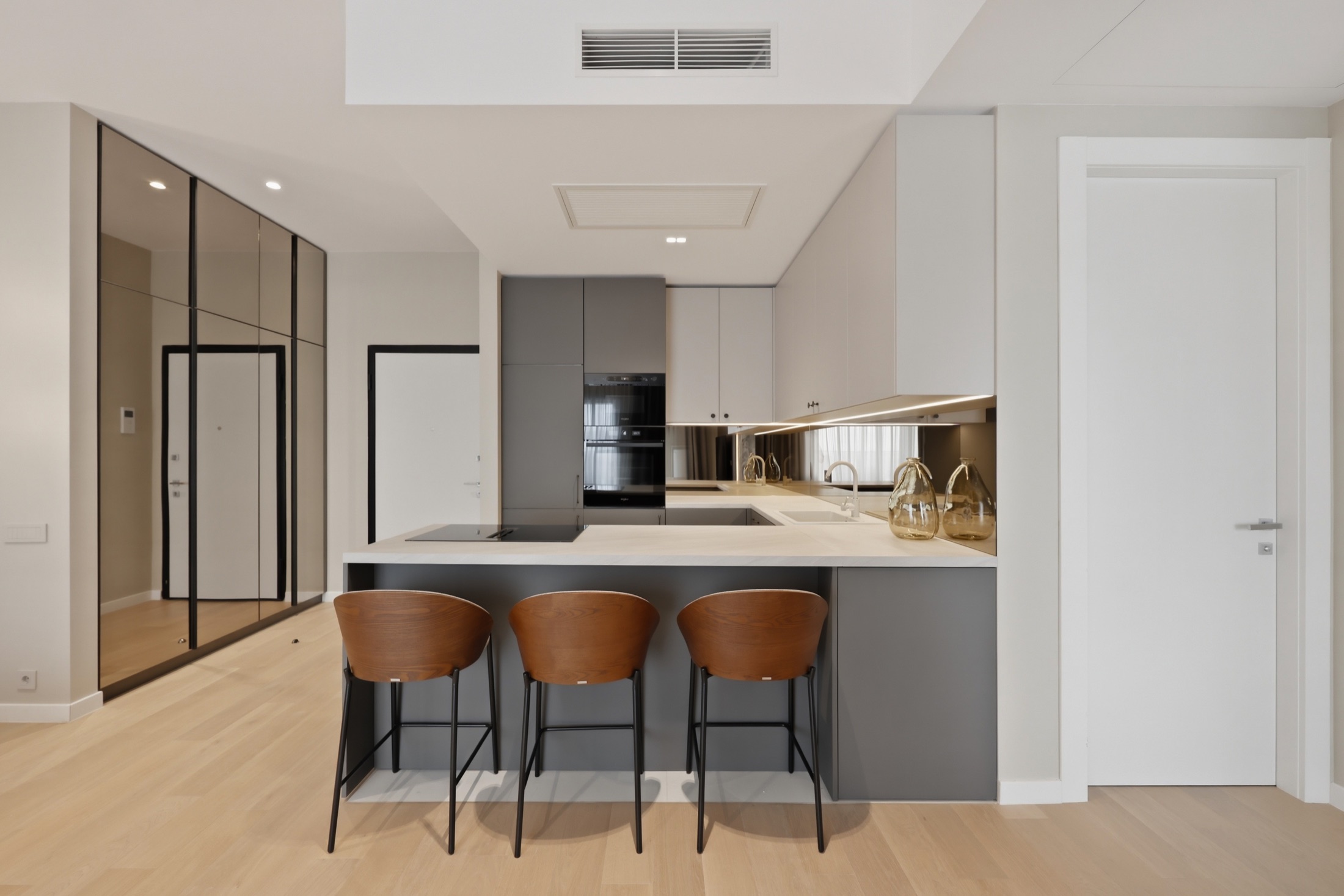 Kitchen island and bar seating in the Elvira One residence