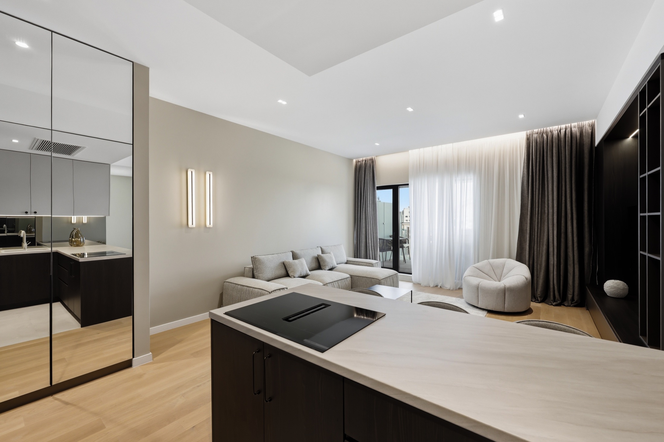 Wide kitchen view showing joinery, island and living-room connection