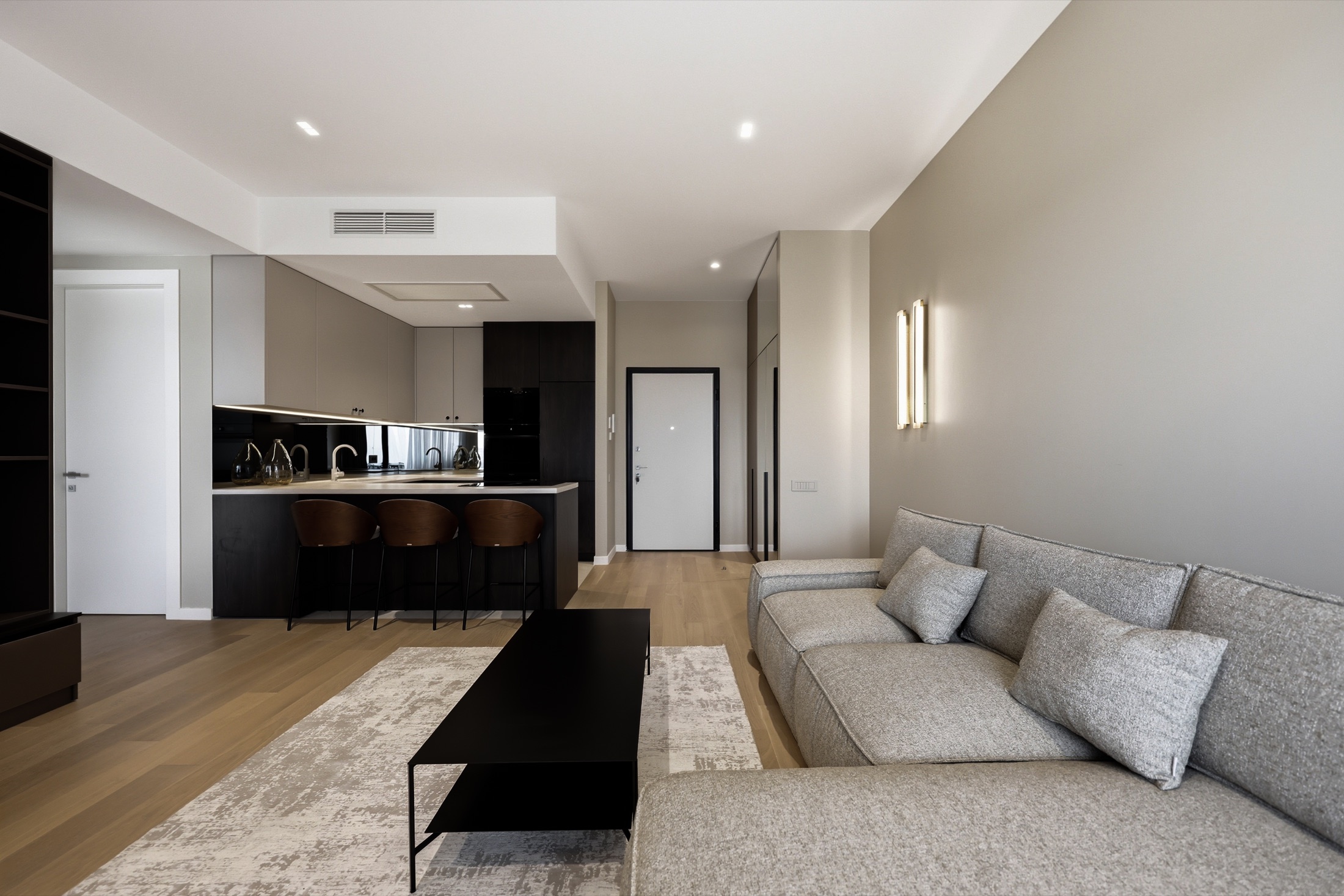 Neutral living room and open kitchen in the Elvira One apartment