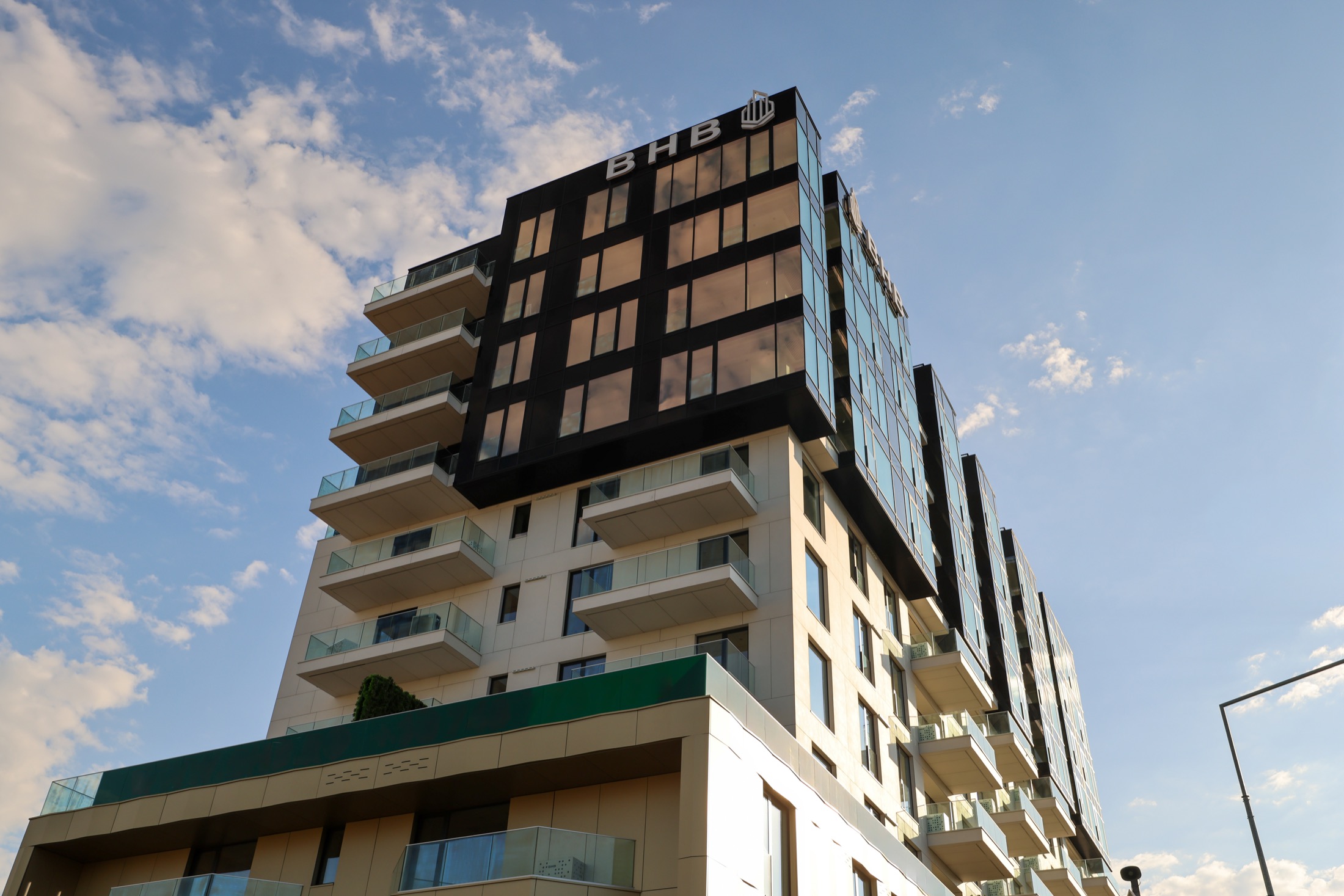 Contemporary Bucharest residential building photographed at golden hour