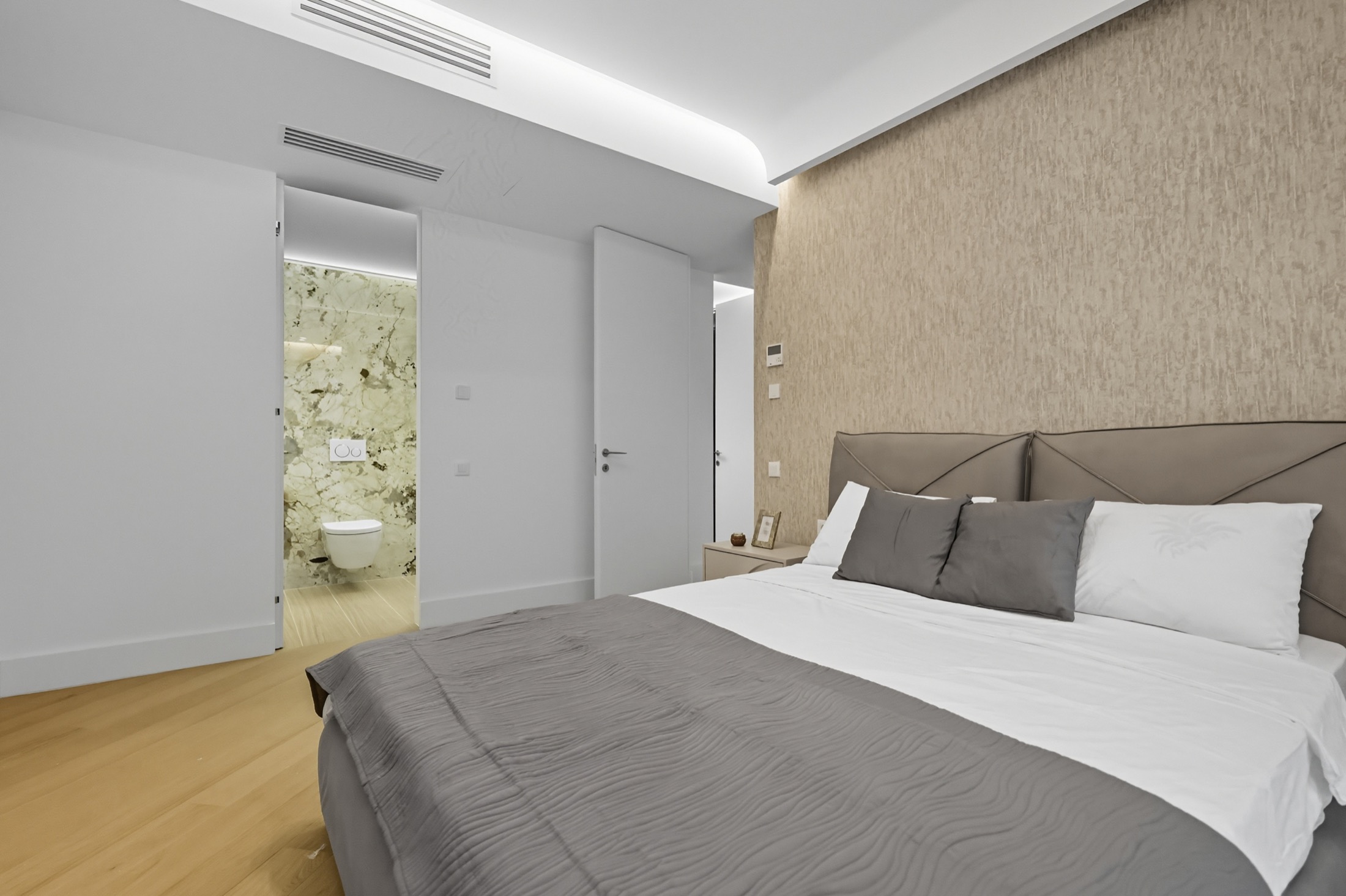 Warm neutral bedroom with bronze curtains